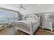 Tranquil main bedroom featuring a king bed, ceiling fan and natural light, with a view at 703 S Waccamaw Dr., Garden City Beach, SC 29576