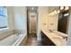 Bathroom featuring double vanity, a soaking tub, and modern fixtures at 7040 Belancino Blvd., Myrtle Beach, SC 29572