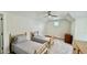 Bedroom with twin beds, carpet, neutral walls, ceiling fan, and natural light from a window at 7040 Belancino Blvd., Myrtle Beach, SC 29572