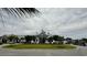Exterior shot of clubhouse with well-manicured lawn and golf carts in the parking area at 7040 Belancino Blvd., Myrtle Beach, SC 29572