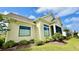 Exterior view of a home featuring a screened-in porch and lush landscaping at 7040 Belancino Blvd., Myrtle Beach, SC 29572