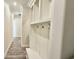 Hallway with wood-look flooring and built-in shelving and coat hooks for organization at 7040 Belancino Blvd., Myrtle Beach, SC 29572