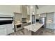 Kitchen with island, stainless appliances, and modern gray cabinets offers style and function at 7040 Belancino Blvd., Myrtle Beach, SC 29572