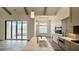 Island kitchen with quartz counters has an open floorplan view to the Gathering room at 7040 Belancino Blvd., Myrtle Beach, SC 29572