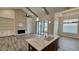 Open-concept living space with a kitchen island, brick fireplace, and sliding doors at 7040 Belancino Blvd., Myrtle Beach, SC 29572