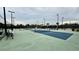 Outdoor pickleball court with blue and green surface, nets, lighting, and fencing at 7040 Belancino Blvd., Myrtle Beach, SC 29572