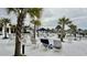 Resort-style pool area featuring sun loungers, umbrellas, palm trees, and a clubhouse at 7040 Belancino Blvd., Myrtle Beach, SC 29572