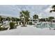 Beautiful resort-style pool with palm trees, lounge chairs, and accessible chair lift at 7040 Belancino Blvd., Myrtle Beach, SC 29572