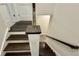 Staircase featuring dark wood stairs and handrail, contrasted by bright white risers at 7040 Belancino Blvd., Myrtle Beach, SC 29572