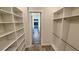 Walk-in closet featuring custom shelving and ample storage space at 7040 Belancino Blvd., Myrtle Beach, SC 29572