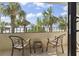 Relax on this balcony with chairs and a table, overlooking a beautiful beach with palm trees at 7100 N Ocean Blvd. # 204, Myrtle Beach, SC 29572