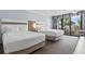 Inviting bedroom featuring two beds with plush bedding and private balcony access at 7100 N Ocean Blvd. # 204, Myrtle Beach, SC 29572