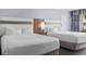 Comfortable hotel bedroom featuring two double beds with soft white linens and modern decor at 7100 N Ocean Blvd. # 204, Myrtle Beach, SC 29572