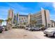 Stunning view of the beach resort exterior with tropical palm trees and ample parking at 7100 N Ocean Blvd. # 204, Myrtle Beach, SC 29572