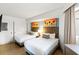 Bright bedroom featuring two beds, modern decor, and palm tree art at 7100 N Ocean Blvd. N # 321, Myrtle Beach, SC 29572
