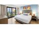 Bright bedroom featuring a queen bed and balcony access at 7100 N Ocean Blvd. N # 321, Myrtle Beach, SC 29572