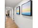 Bright hallway with wood floors and beach themed art at 7100 N Ocean Blvd. N # 321, Myrtle Beach, SC 29572