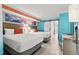 Bright bedroom featuring two beds, light wood floors and a vibrant, decorative seascape mural at 7200 N Ocean Blvd. # 360, Myrtle Beach, SC 29572