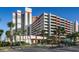A resort building with palm trees in front of it and covered parking next to the tower at 7200 N Ocean Blvd. # 360, Myrtle Beach, SC 29572