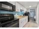 Well-equipped kitchen with sleek, black appliances and crisp white cabinetry at 7200 N Ocean Blvd. # 360, Myrtle Beach, SC 29572