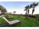 Lawn area with lounge chairs and palm trees overlooking the ocean at 7200 N Ocean Blvd. # 360, Myrtle Beach, SC 29572