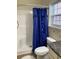 Bright bathroom with a blue shower curtain, white toilet, and tiled floor at 739 Shell Creek Circle # 739, North Myrtle Beach, SC 29582