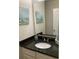 Bathroom with dark granite counters, light cabinets, and seascape art at 739 Shell Creek Circle # 739, North Myrtle Beach, SC 29582