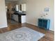 Open-concept living space flowing into a kitchen, featuring modern floors and a blue cabinet at 739 Shell Creek Circle # 739, North Myrtle Beach, SC 29582