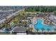Aerial view of a large resort pool area with winding lazy rivers, palm trees, lounge chairs, and a poolside cafe at 750 Howard Ave. # C, Myrtle Beach, SC 29577