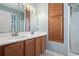Bathroom features a double vanity, wood cabinets, large mirror, and walk-in shower at 750 Howard Ave. # C, Myrtle Beach, SC 29577