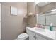 Bathroom featuring a white vanity, framed mirror, toilet, shower with sliding glass door, and decorative wall art at 750 Howard Ave. # C, Myrtle Beach, SC 29577