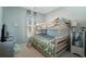 Bright bedroom features a wooden bunk bed with decorative pillows and a colorful tropical themed quilt set at 750 Howard Ave. # C, Myrtle Beach, SC 29577