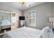 Bedroom with white comforter, mirrored closet, white shuttered windows and ceiling fan at 750 Howard Ave. # C, Myrtle Beach, SC 29577