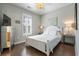 Bedroom features a white bed, bedside tables, wood flooring, and bright natural light at 750 Howard Ave. # C, Myrtle Beach, SC 29577