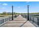 Picturesque boardwalk with vintage lampposts provides a charming waterfront experience under a sunny sky at 750 Howard Ave. # C, Myrtle Beach, SC 29577