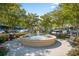 A decorative water fountain surrounded by trees creates a serene focal point in a charming public square at 750 Howard Ave. # C, Myrtle Beach, SC 29577