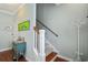 View of hallway with staircase, wood flooring, accent table, and light green walls at 750 Howard Ave. # C, Myrtle Beach, SC 29577
