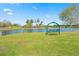 Scenic park view showcasing a lakefront swing on lush green grass under a clear blue sky at 750 Howard Ave. # C, Myrtle Beach, SC 29577