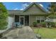 Cozy backyard featuring a screened porch, patio with colorful chairs, and lush greenery for outdoor enjoyment at 750 Pinehurst Ln. # 84A, Pawleys Island, SC 29585