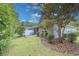 Well-maintained backyard with a patio, screened porch, and manicured landscaping providing a serene outdoor space at 750 Pinehurst Ln. # 84A, Pawleys Island, SC 29585