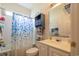 A bathroom with a blue shower curtain, white vanity, and mirror at 750 Pinehurst Ln. # 84A, Pawleys Island, SC 29585