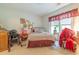 A cozy bedroom with a wrought iron bed, decorative items, and a bright window at 750 Pinehurst Ln. # 84A, Pawleys Island, SC 29585