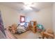 A bright bedroom with a ceiling fan, desk, and window with plaid curtains at 750 Pinehurst Ln. # 84A, Pawleys Island, SC 29585