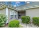 Charming home entrance featuring a covered porch, lush bushes, and manicured landscaping adding to the curb appeal at 750 Pinehurst Ln. # 84A, Pawleys Island, SC 29585