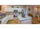 A well-lit kitchen with white cabinets, stainless steel appliances, and an island at 750 Pinehurst Ln. # 84A, Pawleys Island, SC 29585