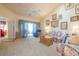 A comfortable living room with a ceiling fan, sliding glass doors, and floral print furniture at 750 Pinehurst Ln. # 84A, Pawleys Island, SC 29585