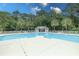 Inviting community pool with plenty of lounge chairs for relaxation, surrounded by palm trees and well-kept grounds at 750 Pinehurst Ln. # 84A, Pawleys Island, SC 29585