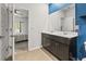 Bright bathroom featuring a double vanity, tile floors, and a doorway that leads to a bedroom at 751 Dusty Pine Way, Myrtle Beach, SC 29588