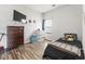Bedroom with wood floors, a TV, a dresser, and a window at 751 Dusty Pine Way, Myrtle Beach, SC 29588