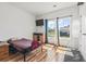 Bedroom with natural light streaming through the large windows, TV, and hardwood floors at 751 Dusty Pine Way, Myrtle Beach, SC 29588